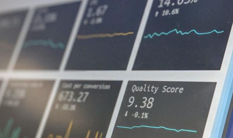 A close up of some small graphs. The closest graph in focus reads "Quality score, 9.38%£"