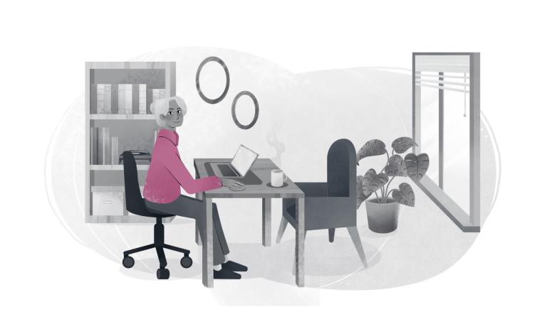 Care worker sat at a desk with a laptop