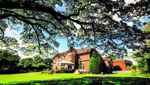 Old Rectory, a Care Home in Staffordshire, surrounded by trees and grass