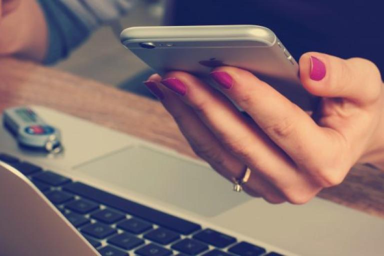 Image of a hand holding a mobile phone