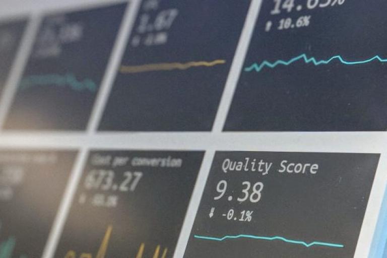 A close up of some small graphs. The closest graph in focus reads "Quality score, 9.38%£"