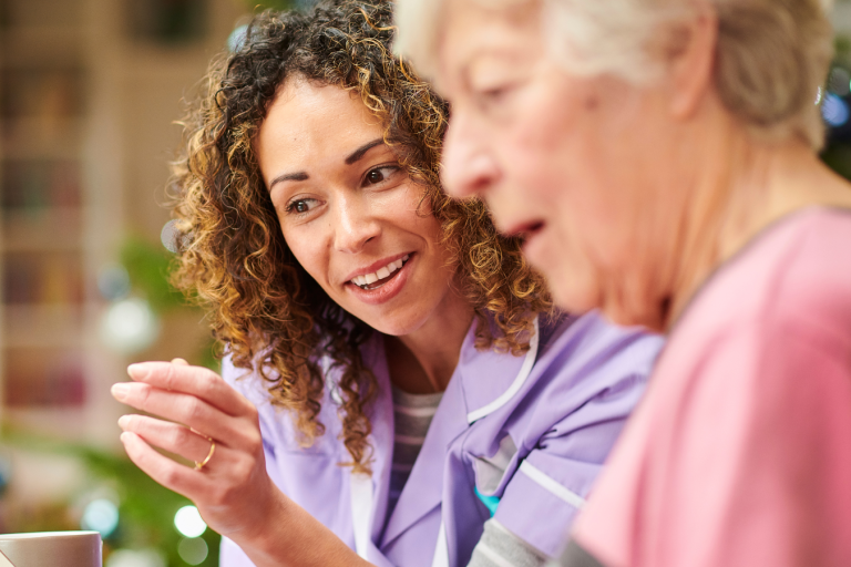 Carer talking to elderly woman